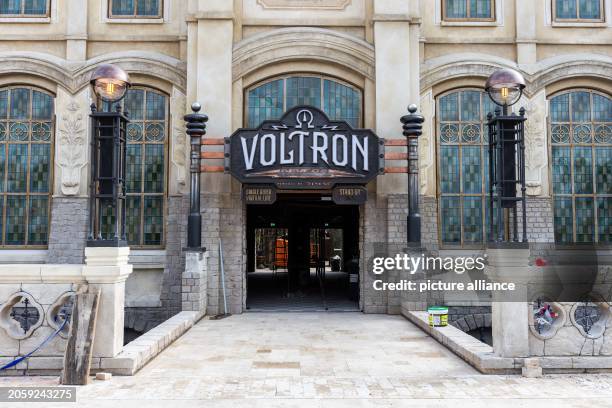 March 2024, Baden-Württemberg, Rust: A sign reading "VOLTRON Nevera powered by Rimac" hangs above the entrance to the building of the roller coaster...