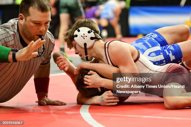 The referee slaps the mat as Shenedehowa's Stevo Poulin, top, pins his opponent in the 113 lb weight class match for Div. L during the State...