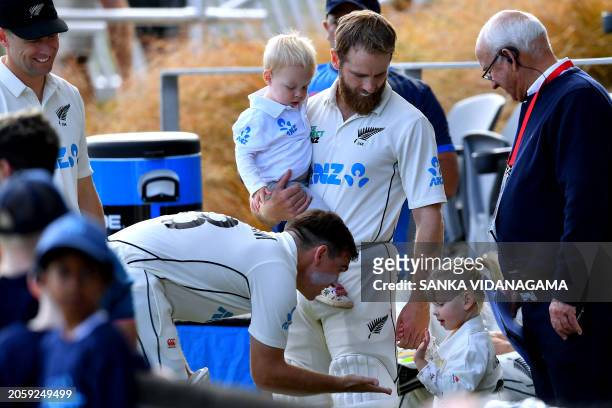 New Zealand's Tom Latham talks with teammate Kane Williamson's daughter ahead of the day one play of second cricket Test match between New Zealand...
