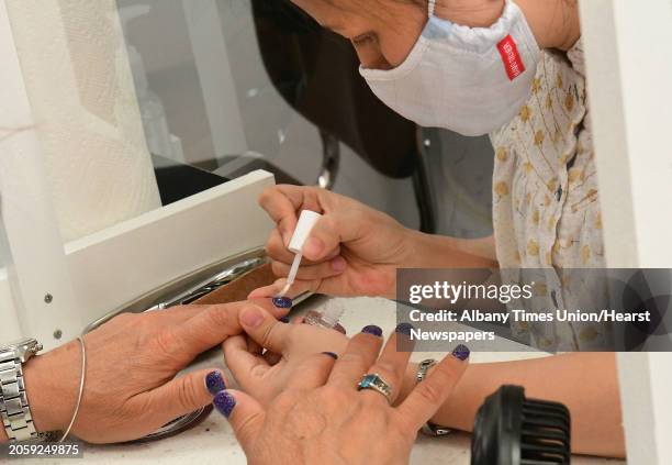 Customers receive manicures separated by plastic barriers from each other and from the manicurist at ProNails of Saratoga located on Broadway on...