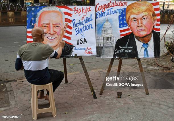 Teacher from Gurukul school of art paints USA presidential election posters of Joe Biden and Donald Trump in Mumbai.