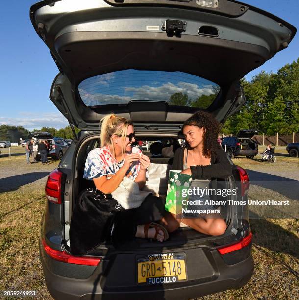 Rosie Dollard and her friend Maleia Batts, both of Saratoga Springs, enjoy popcorn in the back of a car as Malta Drive-In holds Appreciation Night...