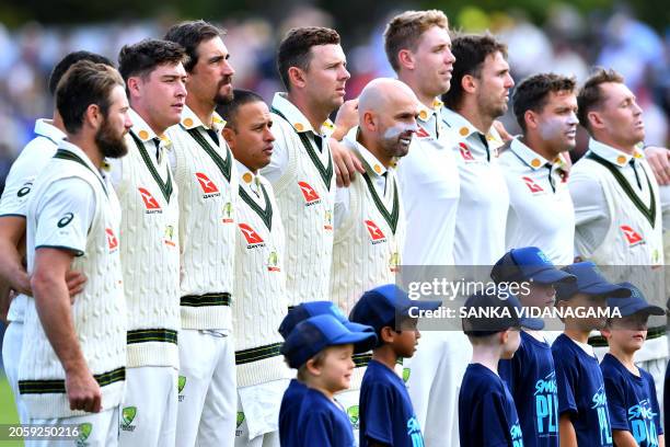 Team Australia line up for the national anthem on day one of the second Test cricket match between New Zealand and Australia at Hagley Oval in...