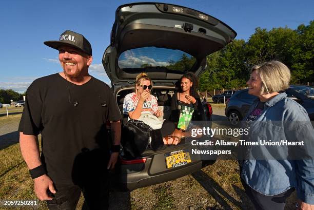 Rosie Dollard and her friend Maleia Batts, both of Saratoga Springs, enjoy popcorn in the back of a car as Malta Drive-In holds Appreciation Night...