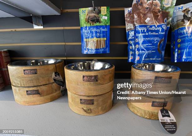 Dog bowls are seen below treats on shelves at Chow Bella, an indoor, climate controlled canine social club, which recently opened their doors for...