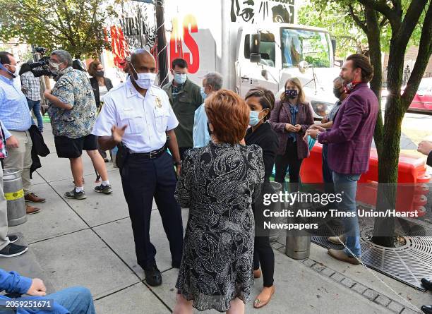 Albany Police Chief Eric Hawkins talks to Mayor Kathy Sheehan, center, outside Pint Sized after the mayor made an announcement regarding improvements...