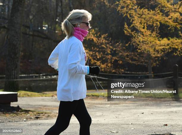 Woman is seen jogging near Buckingham Pond on Thursday, Nov. 19, 2020 in Albany, N.Y.