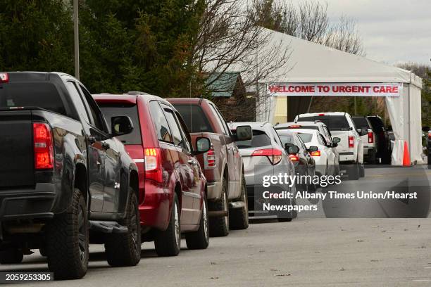 Cars are seen lined up at a drive-through COVID-19 testing tent set up in the Wilton Medical Arts parking lot on Friday, Dec. 4, 2020 in Wilton, N.Y.