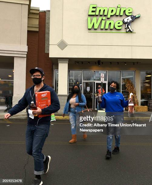 People are seen leaving Empire Wine with liquor they most likely will be drinking to celebrate New Years Eve on Thursday, Dec. 31, 2020 in Albany,...
