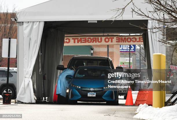 Car is seen in the drive-through testing tent in the parking lot of an Urgent Care on Tuesday, Jan. 19, 2021 in Wilton, N.Y.