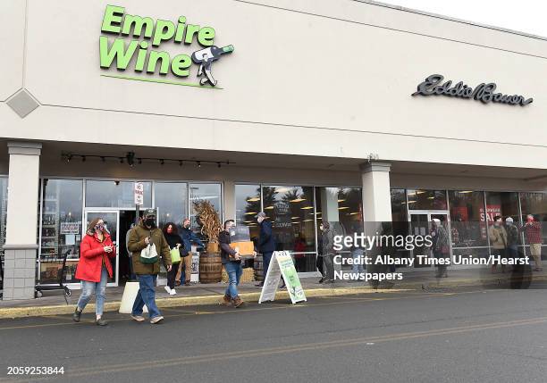 People wait in line outside of Empire Wine to buy liquor they most likely will be drinking to celebrate New Years Eve on Thursday, Dec. 31, 2020 in...