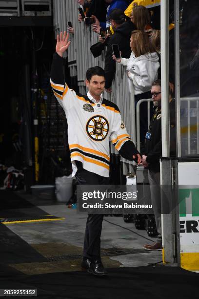 Adam McQuaid of the Boston Bruins waves to the fans during a pregame "Return of a Champion Era Night" ceremony before the game against the Toronto...