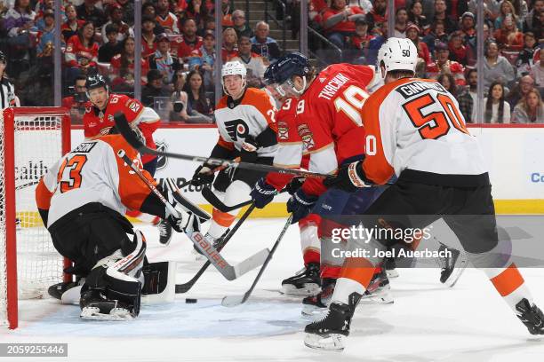 Goaltender Samuel Ersson of the Philadelphia Flyers stops a shot by Sam Reinhart of the Florida Panthers at the Amerant Bank Arena on March 7, 2024...