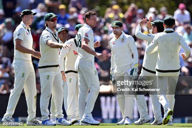 Josh Hazlewood of Australia is congratulated by team mates after dismissing Kane Williamson of New Zealand during day one of the Second Test in the...