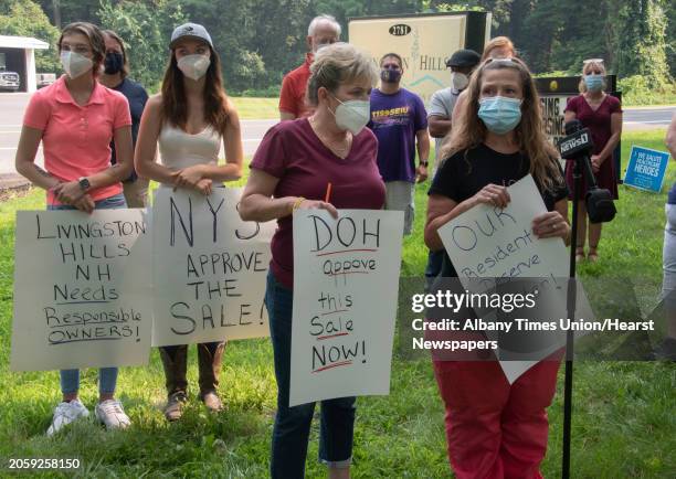 Dawn Simmons, LPN, right, talks at the microphone with Donna Decker, CNA, as 1199SEIU holds a press conference outside Livingston Hills Nursing and...