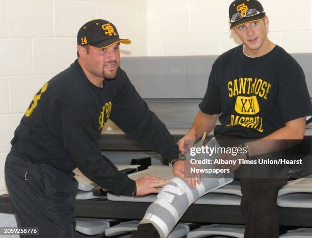 Albany Times Union photo by Lori Van Buren -- St. Rose baseball coach Casey O'Connor helps put a brace around the leg of freshman Derek Marshall, 18...