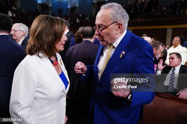 Senate Majority Leader Chuck Schumer chats with former House Speaker, Rep. Nancy Pelosi on the House floor ahead of the annual State of the Union...