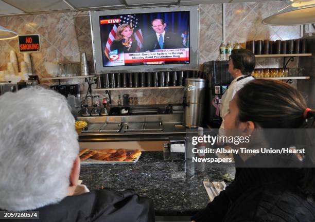 Times Union staff photo by Lori Van Buren -- Waitstaff and customers at the Wolf Road Diner in Colonie, NY watch Governor Eliot Spitzer announce his...