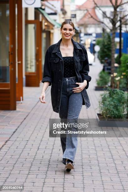 Rebecca Kunikowski, wearing a black top by JJXX, black Jeans by JJXX, a black Jeans jacket by Diesel, a ring by Swarovski, earrings by Swarovski and...