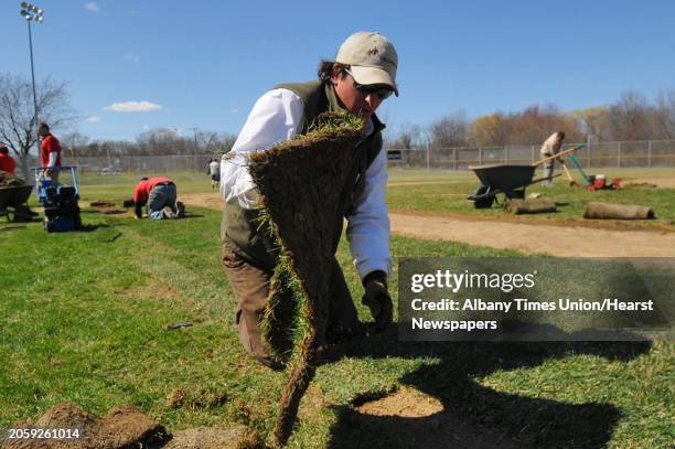 Times Union staff photo by Lori Van Buren -- Dennis Brooks, of The Brickman Group lays down sod as he works on a field at Berkley Park in Cohoes, NY...