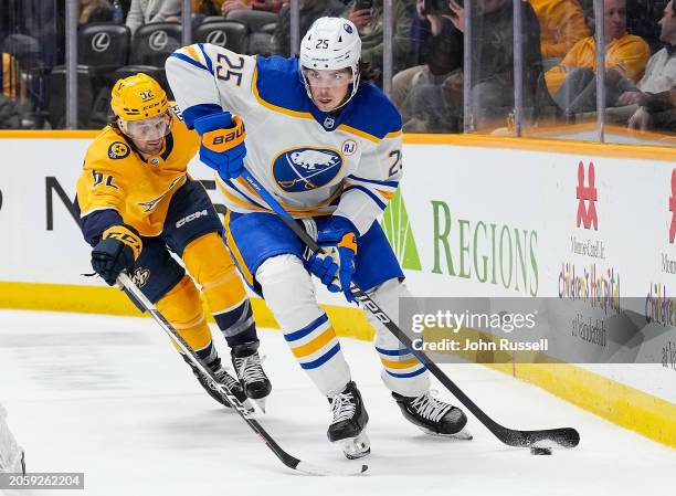 Owen Power of the Buffalo Sabres skates against Tommy Novak of the Nashville Predators during an NHL game at Bridgestone Arena on March 7, 2024 in...