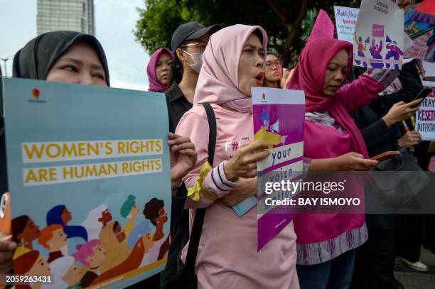 Indonesian women march during a rally while commemorating International Women's Day in Jakarta on March 8 2024, and demand the Indonesian government...