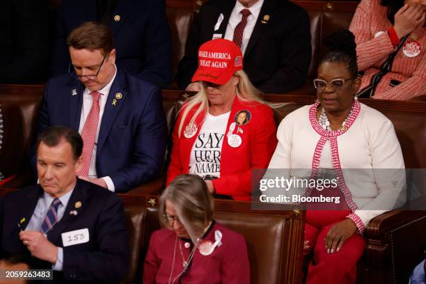 Representative Marjorie Taylor Green, a Republican from Georgia, center, wears a "Make America Great Again" hat in the House Chamber during a State...