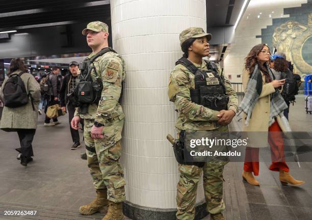 Security forces, including National Guard troops and police, take security measures at a subway station in New York, United States on March 07, 2024....