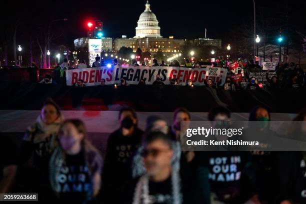 Demonstrators with a coalition of Pro-Palestinian groups attempt to block President Joe Biden's motorcade route during a protest near the U.S....