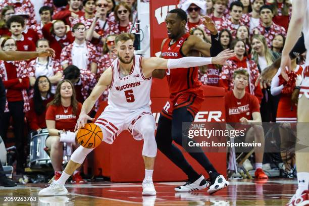 Wisconsin forward Tyler Wahl tries to get to the basket past Rutgers forward Aundre Hyatt during a college basketball game between the University of...