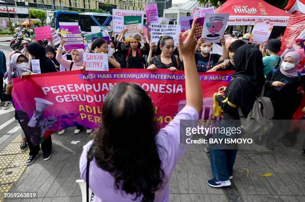 Indonesian women march during a rally while commemorating International Women's Day in Jakarta on March 8 2024, and demand the Indonesian government...