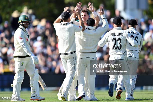 Matt Henry of New Zealand is congratulated by team mates after dismissing Usman Khawaja of Australia during day one of the Second Test in the series...