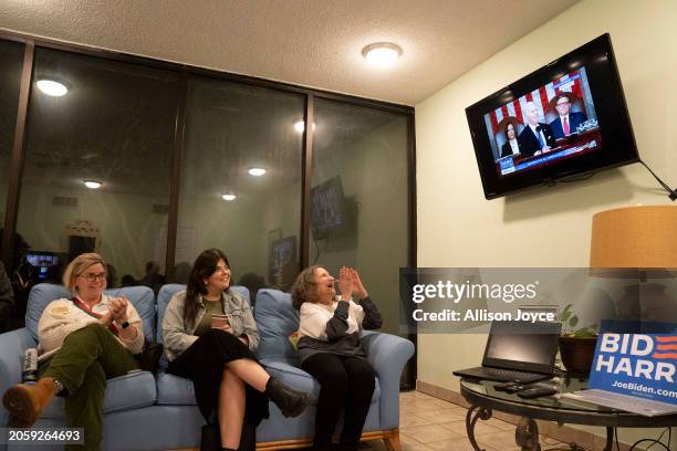 People watch President Biden speak at a State of the Union watch party organized by the New Hanover Democratic Party on March 7, 2024 in Wrightsville...