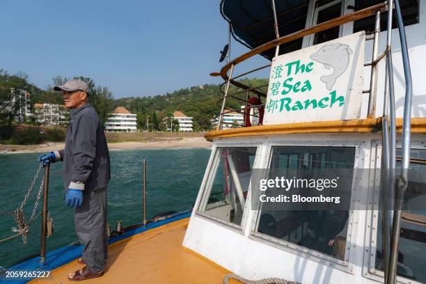 Sailor on an inter-island ferry from Cheung Chau to the Sea Ranch residential development, built by Hutchison Whampoa Ltd., on Lantau Island in Hong...