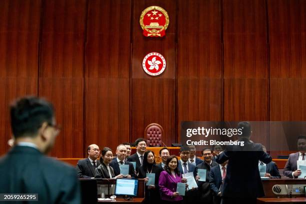 Lawmakers pose with copies of the proposed Safeguarding National Security Bill following a special meeting for Basic Law Article 23 legislation at...