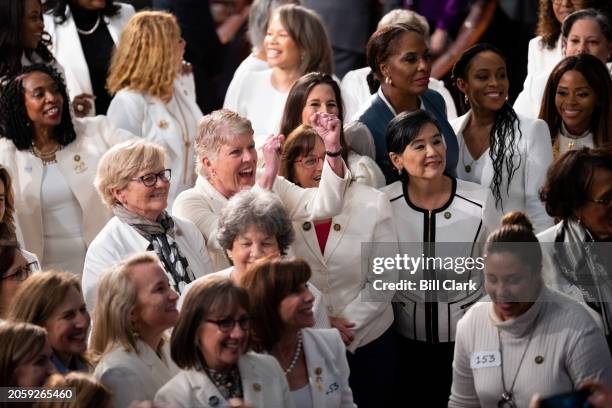 Democratic Congressional women wearing white pose for a group photo on the House floor before the start of President Joe Biden's State of the Union...