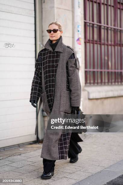 Guest wears sunglasses, a black turtleneck , a double breasted long gray coat with checkered / checked pattern printed and brown patchwork details, a...