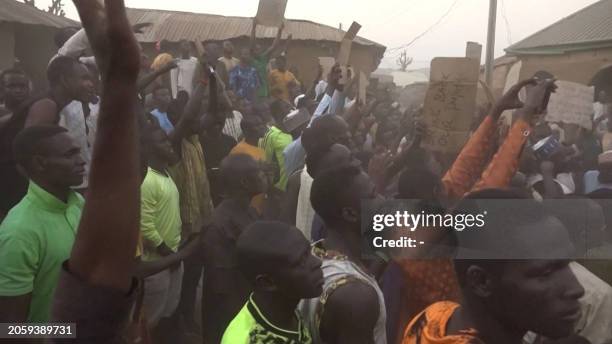 This video grab taken from an AFPTV video on March 7, 2024 shows families of abducted pupils gathering during the visit of the Kaduna State governor...