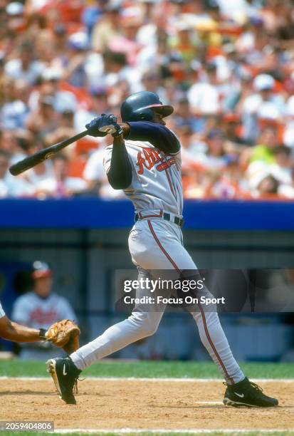 Michael Tucker of the Atlanta Braves bats against the New York Mets during Major League Baseball game circa 1997 at Shea Stadium in the Queens...