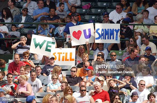 Fans of the Chicago Cubs and Sammy Sosa display signs saying "We still Love U Sammy" during a game between the Cubs and the Tampa Bay Devil Rays on...