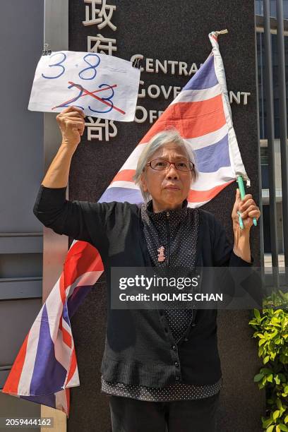 Hong Kong activist Alexandra Wong, also known as Grandma Wong, waves Britain's Union Jack as she holds a solo protest in front of the Central...