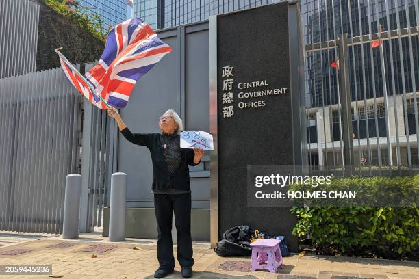 Hong Kong activist Alexandra Wong, also known as Grandma Wong, waves Britain's Union Jack as she holds a solo protest in front of the Central...