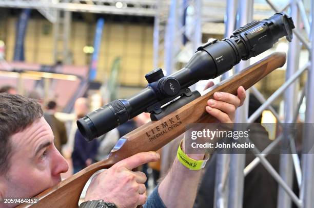 Visitor tries out a Liemke Thermal Optics rifle scope during the British Shooting Show at NEC Arena on February 23, 2024 in Birmingham, England. The...