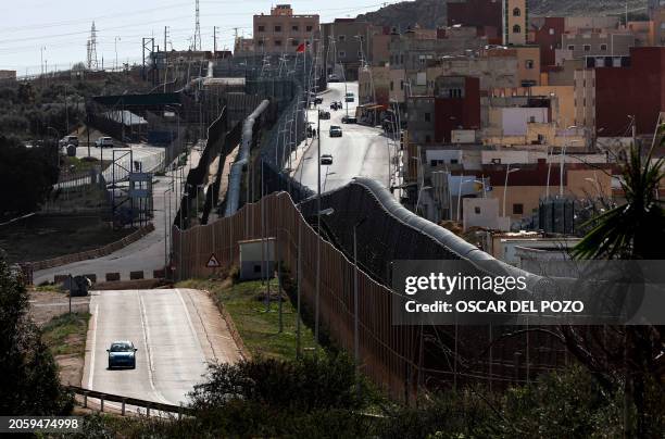This picture taken on February 24, 2024 in Melilla shows a view of the fences and wall marking the border between Morocco and Spain's North African...