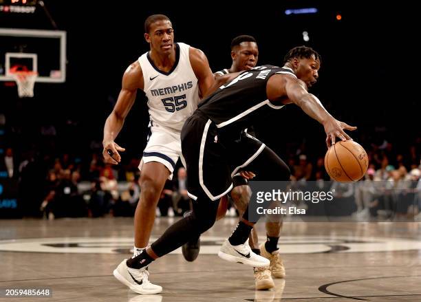 Dorian Finney-Smith of the Brooklyn Nets goes after the ball as Trey Jemison of the Memphis Grizzlies looks on during the first half at Barclays...