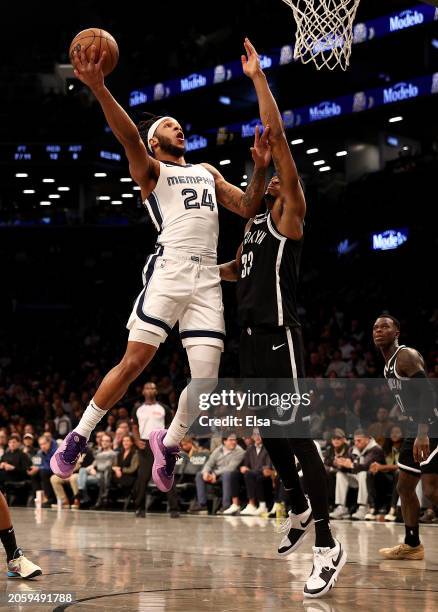 Lamar Stevens of the Memphis Grizzlies heads for the net as Nic Claxton of the Brooklyn Nets during the first half at Barclays Center on March 04,...