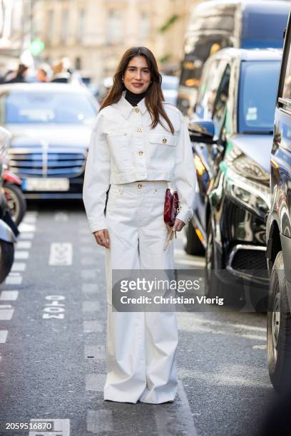 Belen Hostalet wears white cropped jacket, wide leg pants, red bag outside Zimmermann during the Womenswear Fall/Winter 2024/2025 as part of Paris...