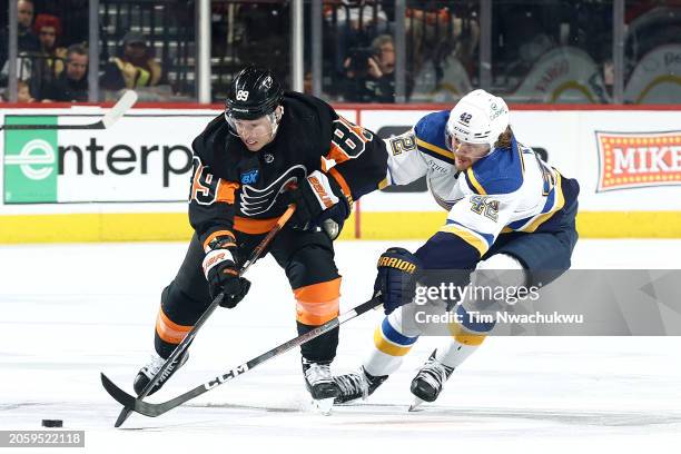 Cam Atkinson of the Philadelphia Flyers and Kasperi Kapanen of the St. Louis Blues challenge for the puck during the second period at the Wells Fargo...