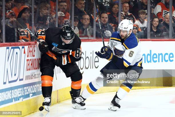 Cam Atkinson of the Philadelphia Flyers and Marco Scandella of the St. Louis Blues challenge for the puck during the second period at the Wells Fargo...