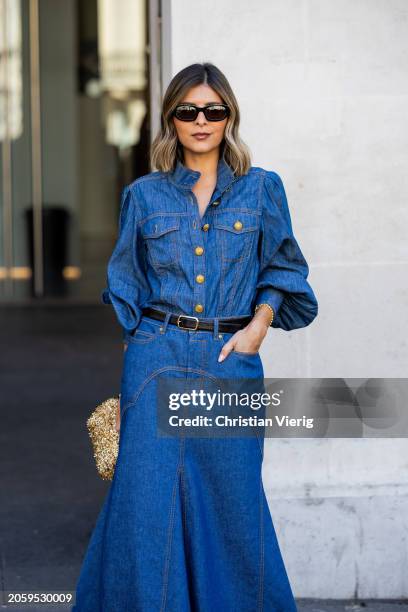 Guest wears denim shirt, wide leg pants, black belt, golden bag outside Zimmermann during the Womenswear Fall/Winter 2024/2025 as part of Paris...